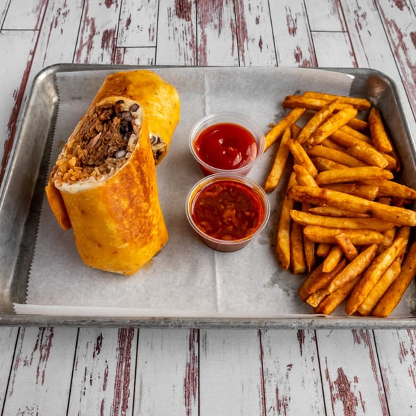Calle Taco's carne asada burrito, cut in half, with a side of golden fries and two dipping sauces.
