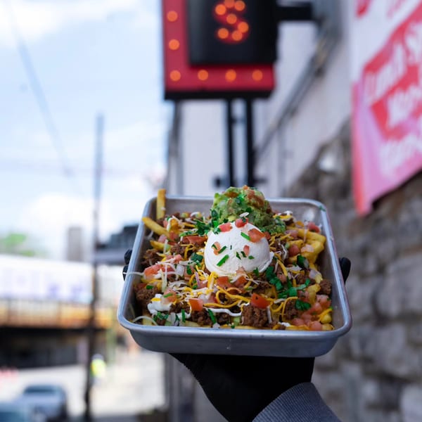 Calle Taco's loaded fries with ground beef, cheese, sour cream, guacamole, and pico de gallo.